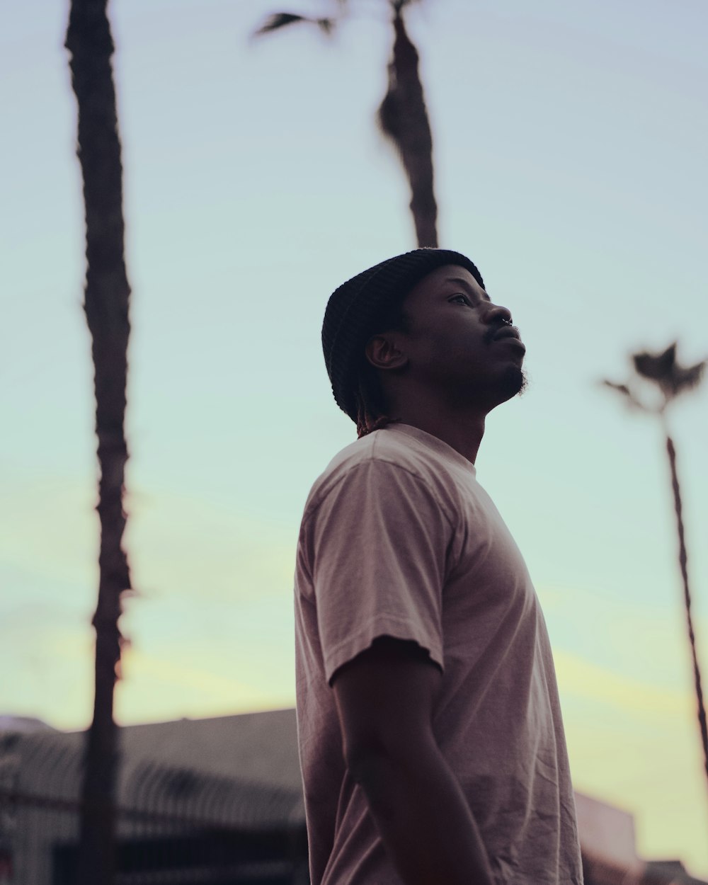 a man standing in front of palm trees