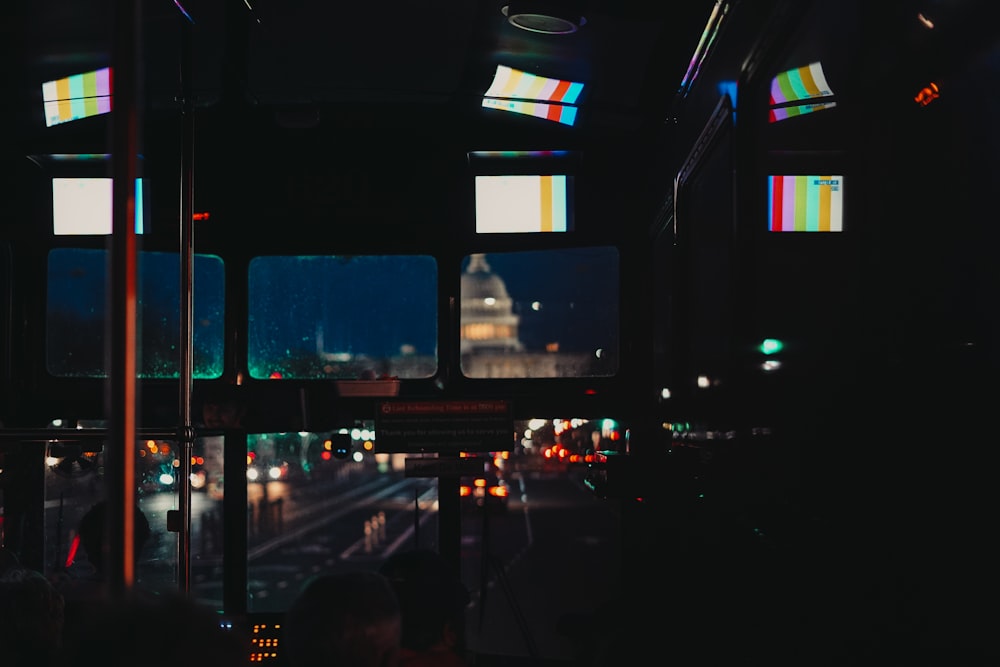 a view of a city at night from inside a bus