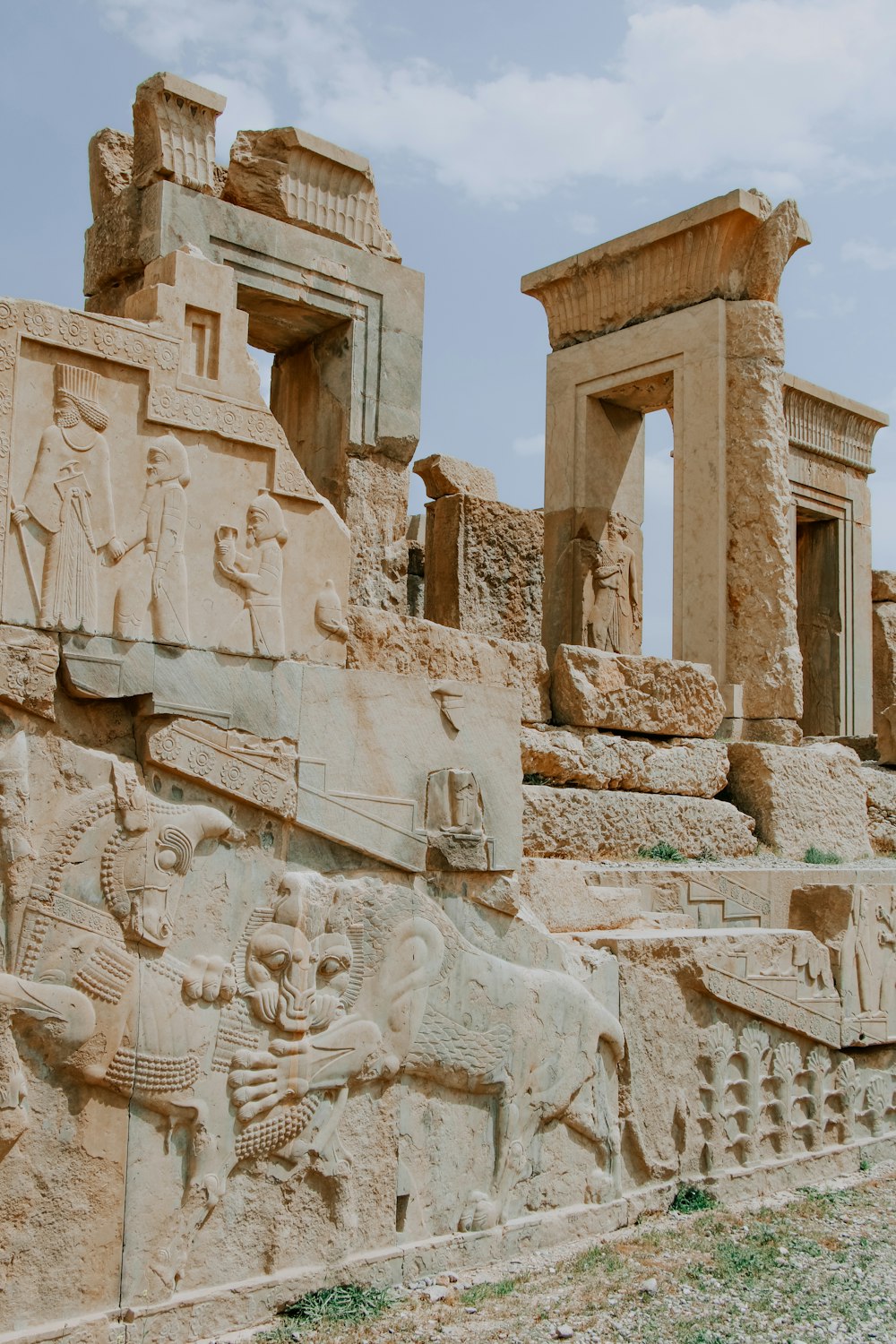 a stone wall with carvings of animals and people on it