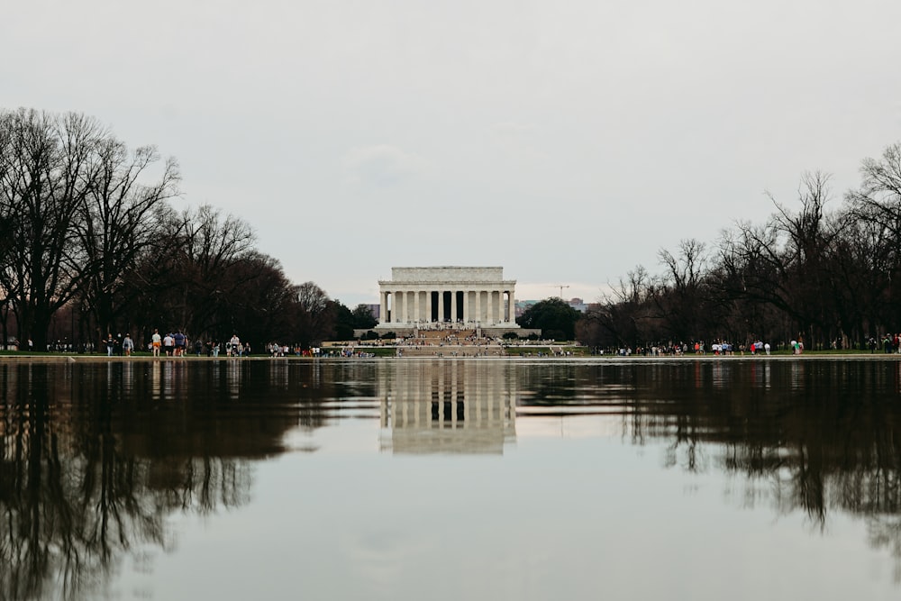 a large body of water with a building in the background