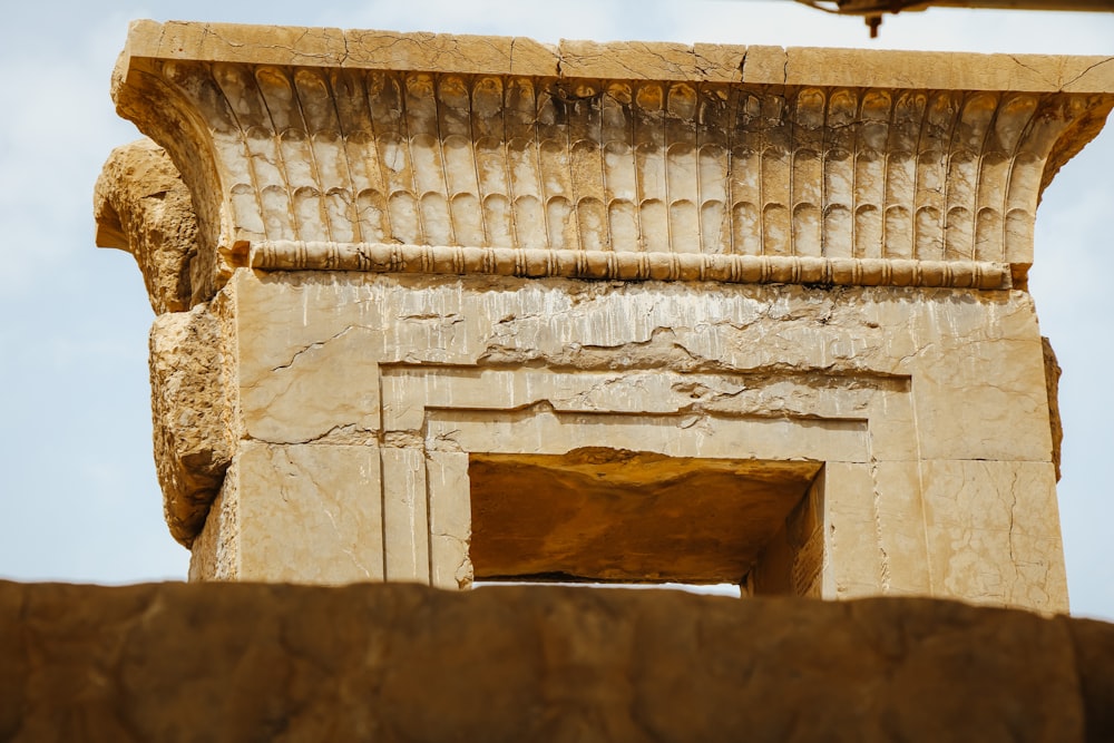 a close up of a stone structure with a sky in the background