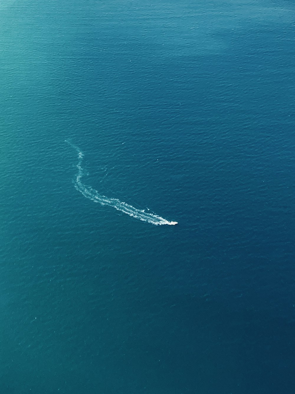 a small boat in the middle of a large body of water