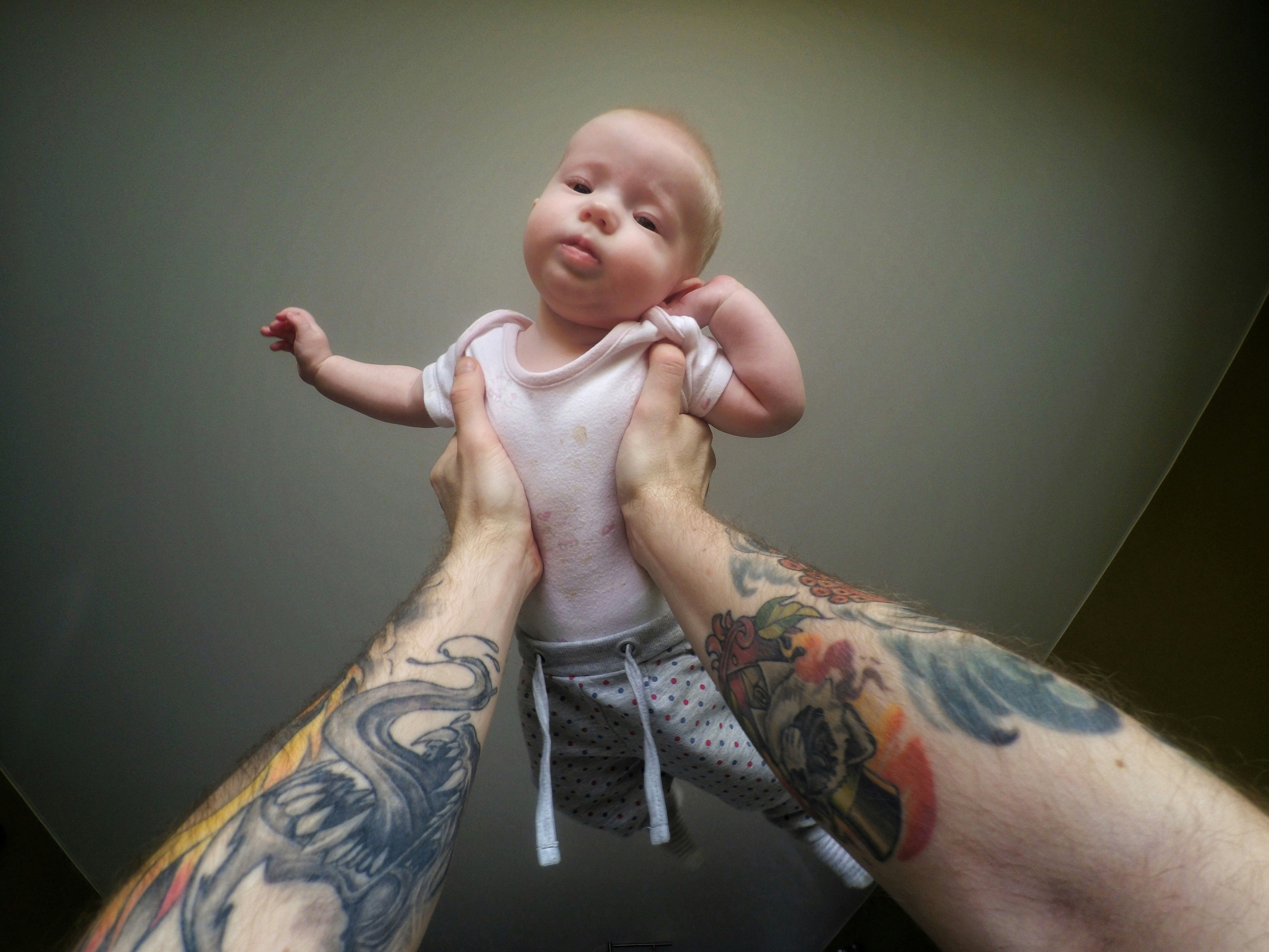 a man holding a baby in his arms