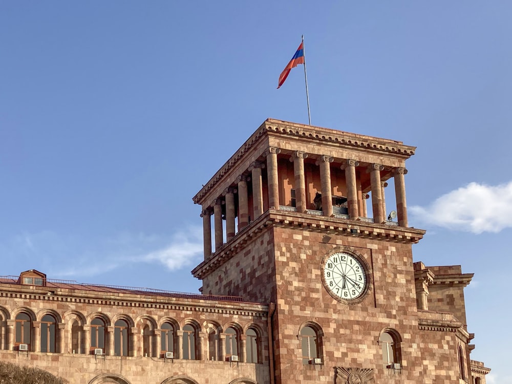 a clock tower with a flag on top of it