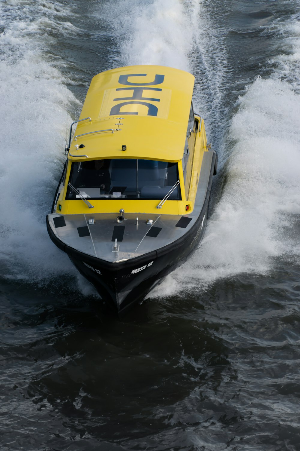 a yellow and black speed boat in the water