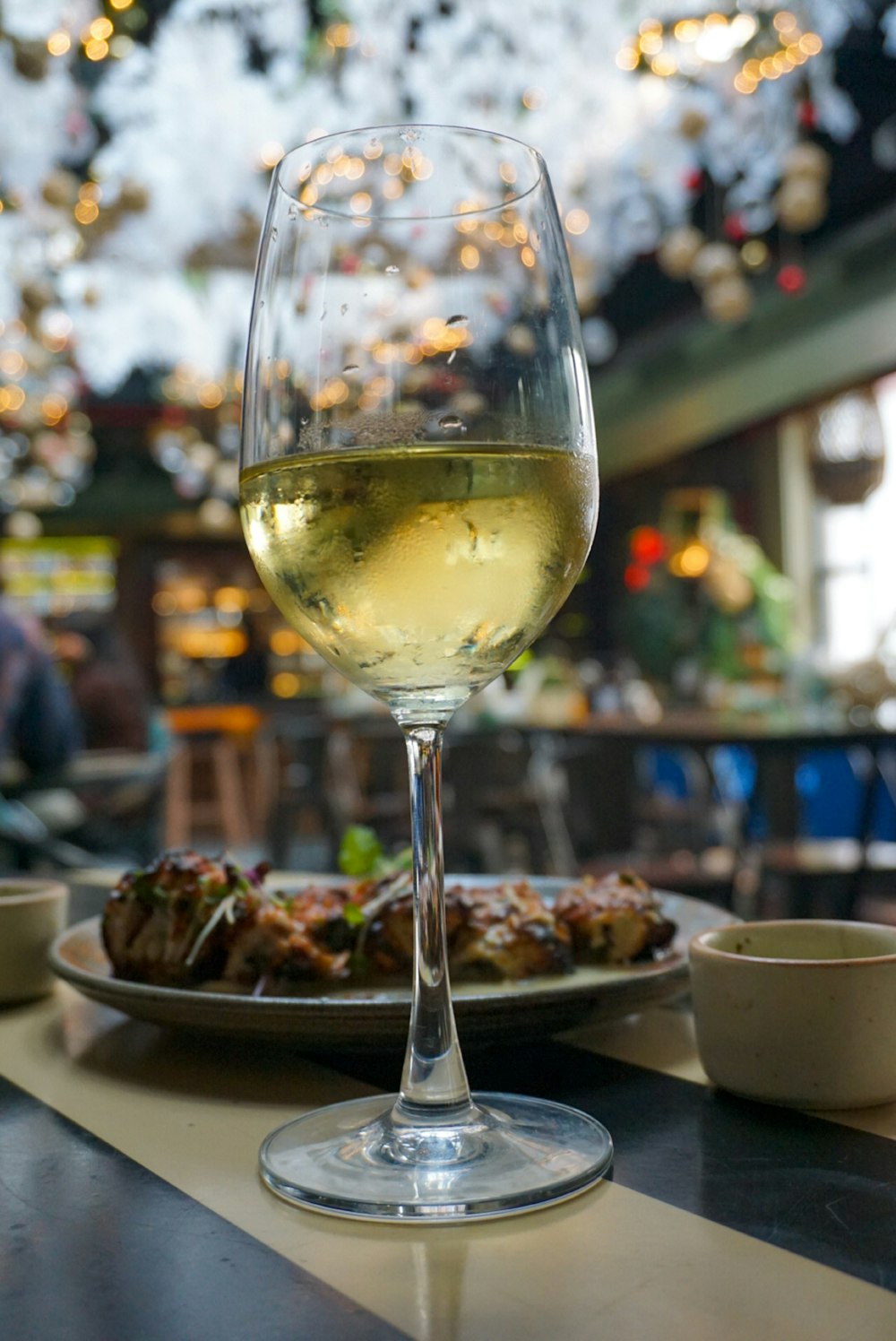 a glass of wine sitting on top of a table