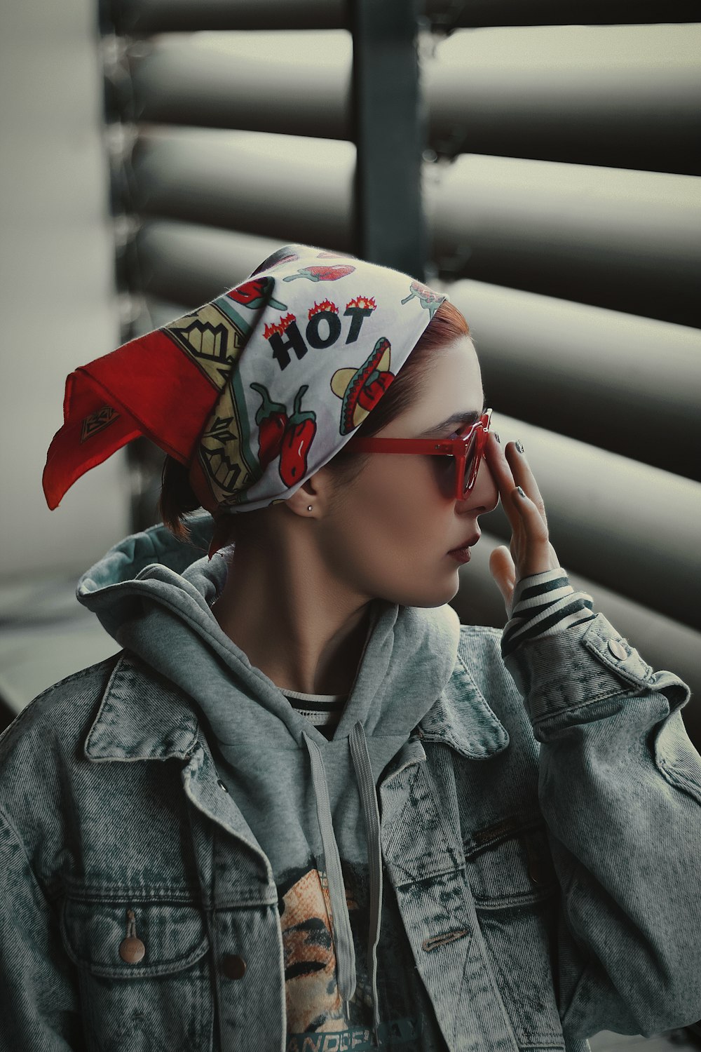 a woman with a bandana on her head talking on a cell phone