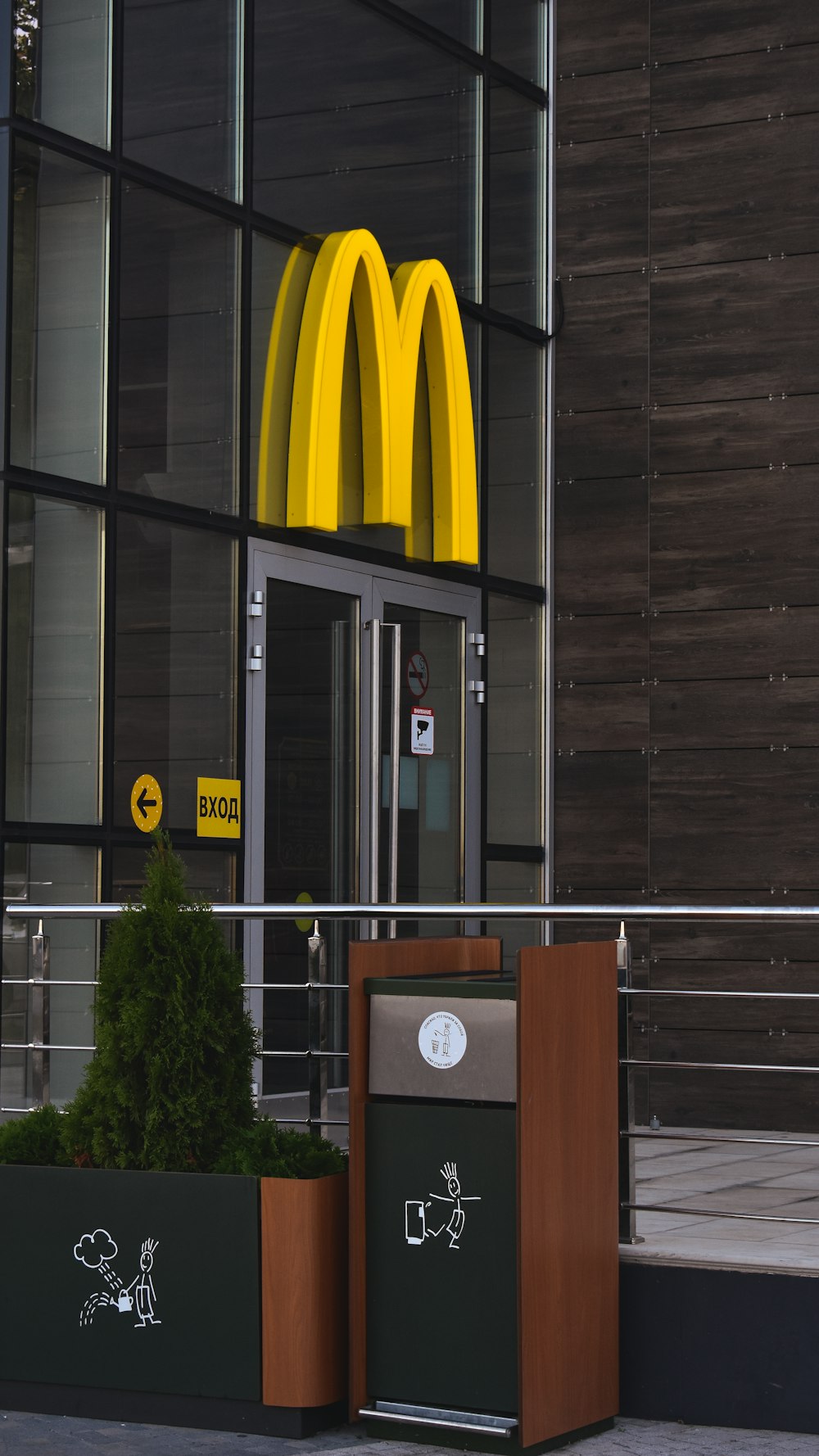 a mcdonald's restaurant with a large yellow mcdonald's sign