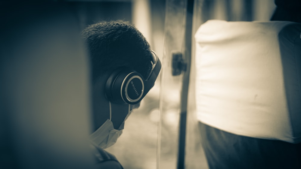 a man wearing headphones in front of a mirror