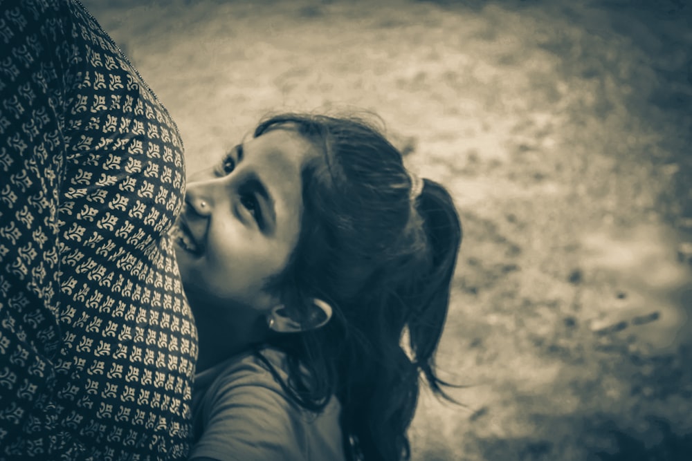 a little girl holding onto a large umbrella