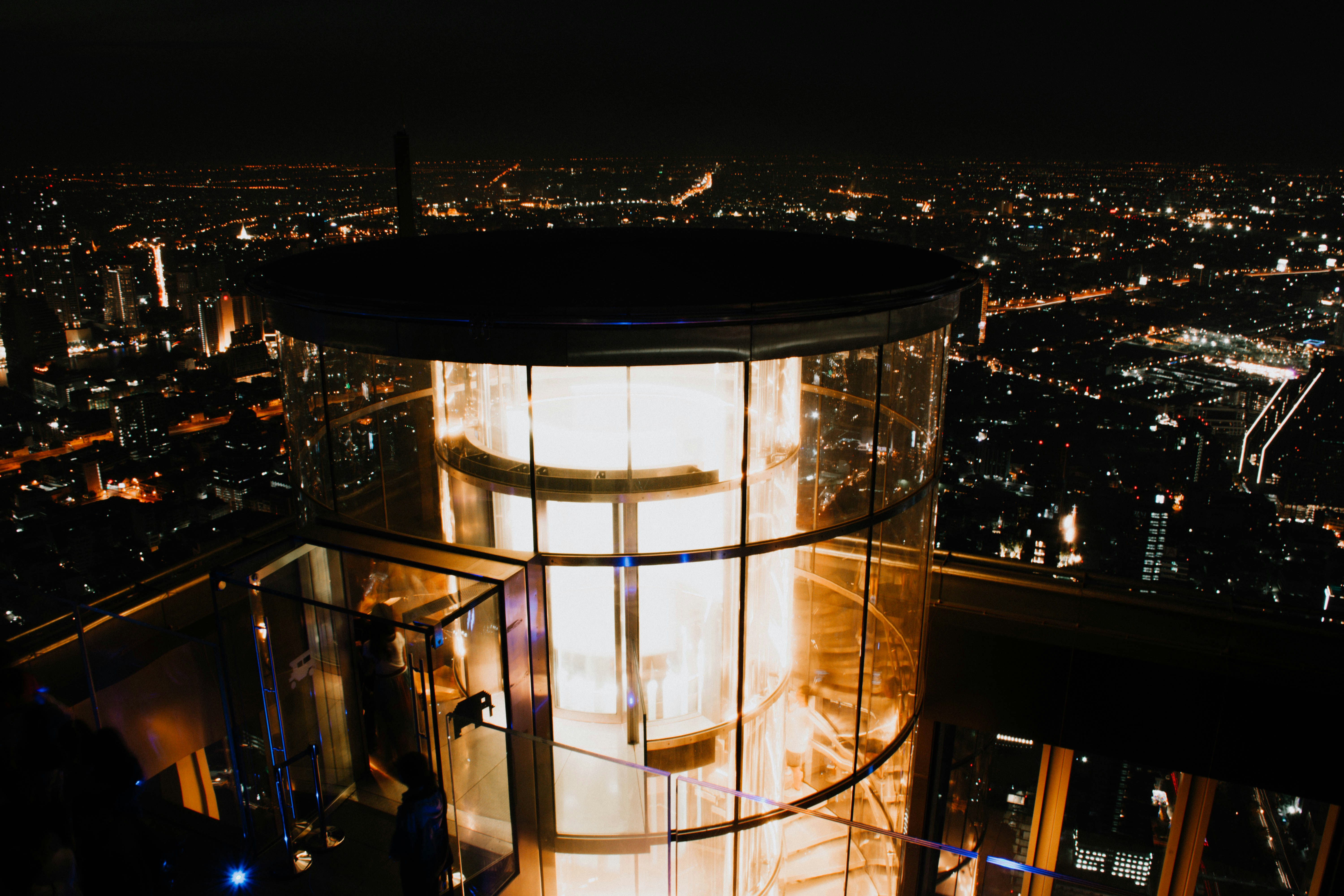 A view of a city at night from the top of a building photo – Free Lift ...