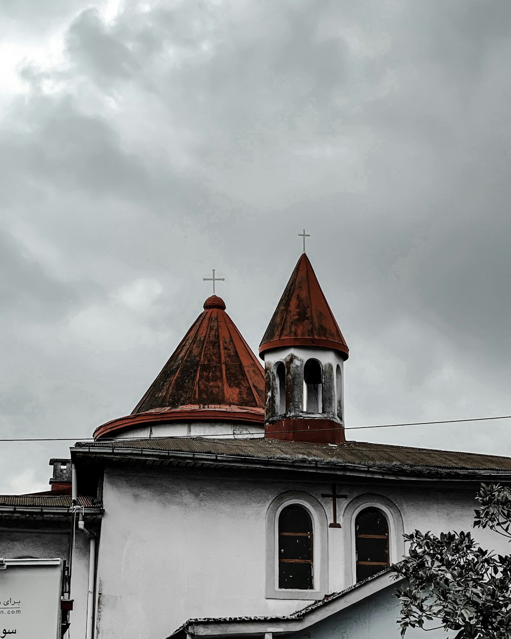 a white building with a red roof and a clock tower