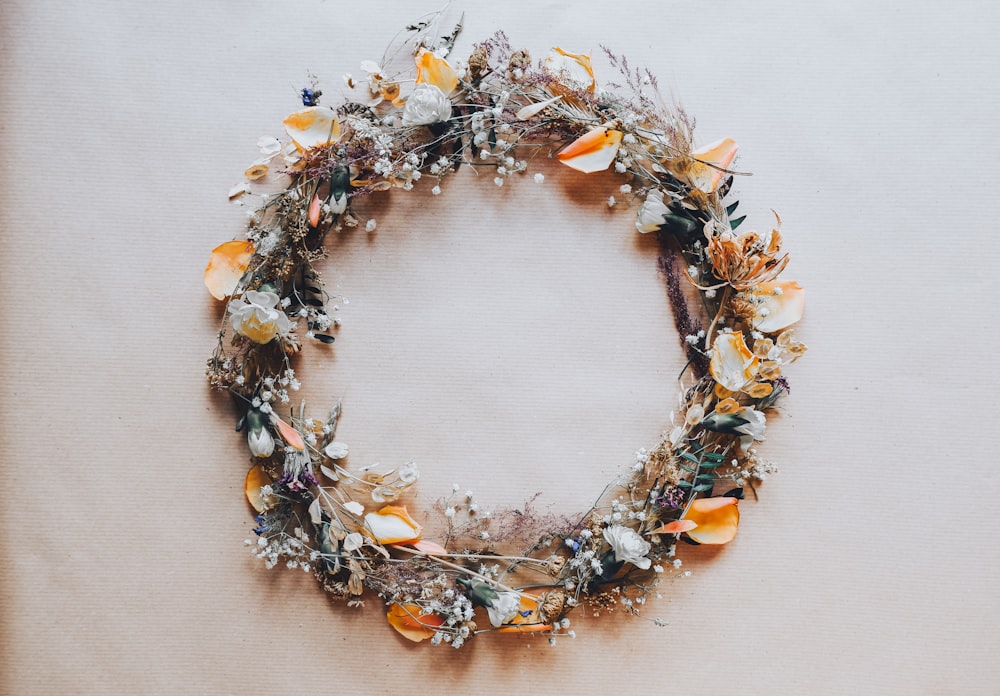 a wreath of flowers and leaves on a table