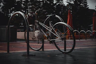 A cyclist locking up their bike outside a cozy café on a rainy afternoon.