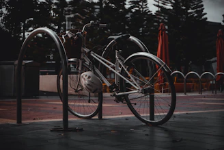 A cyclist locking up their bike outside a cozy café on a rainy afternoon.