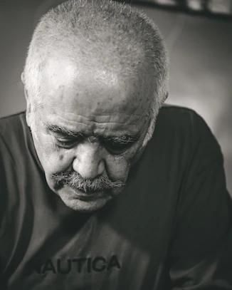 a black and white photo of a man with a mustache