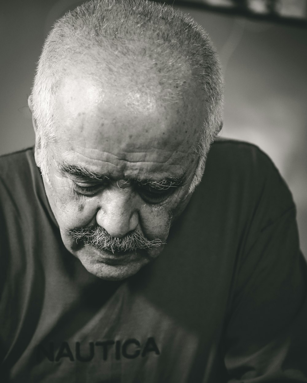 a black and white photo of a man with a mustache