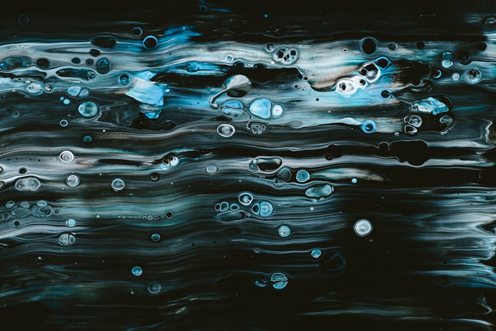 a painting of water and bubbles on a black background