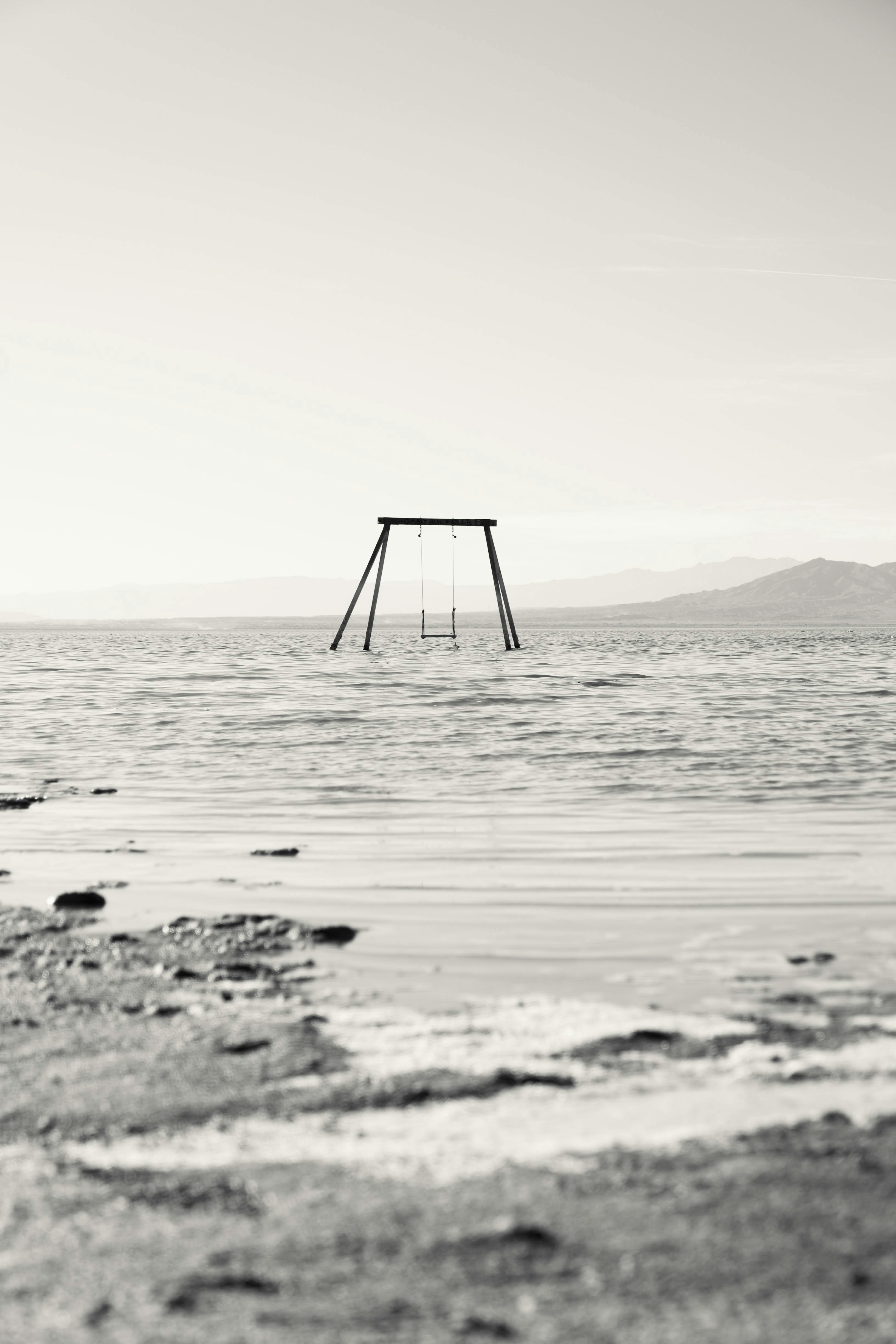 A swing sitting in the middle of a body of water photo Free Salton