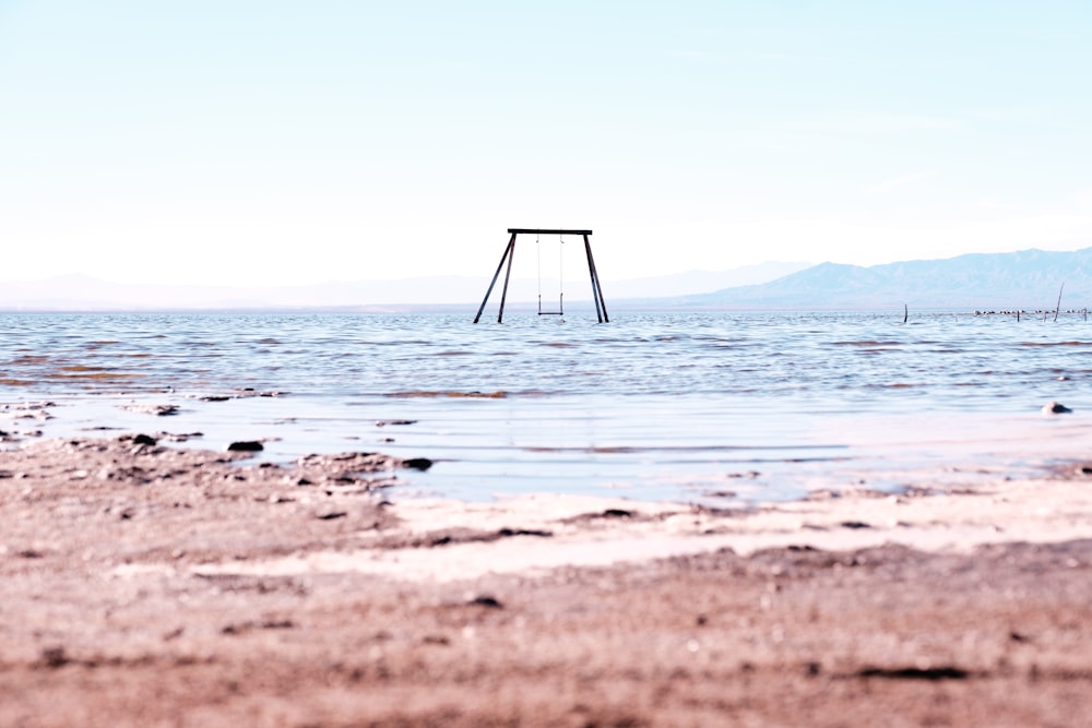 a swing in the middle of a body of water