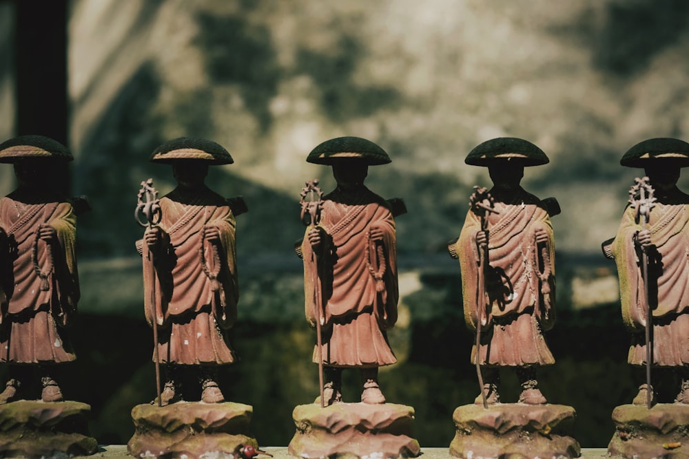 a row of statues of buddhas on display