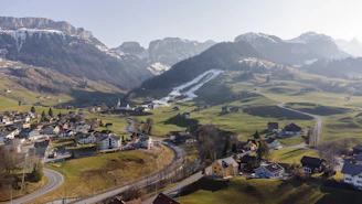 A serene Himalayan valley showcasing diverse alpine flora and traditional villages.