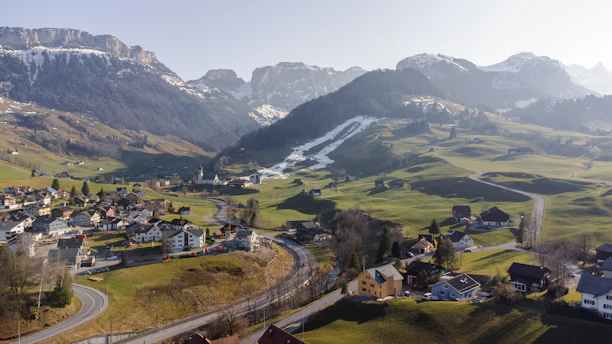 A serene Himalayan valley showcasing diverse alpine flora and traditional villages.