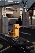 Close-up of an automatic boom barrier with RFID scanner at a parking entrance