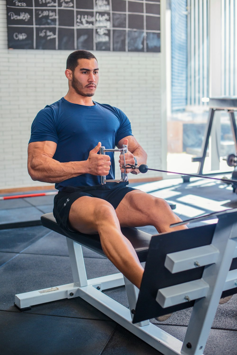 a man sitting on a bench in a gym