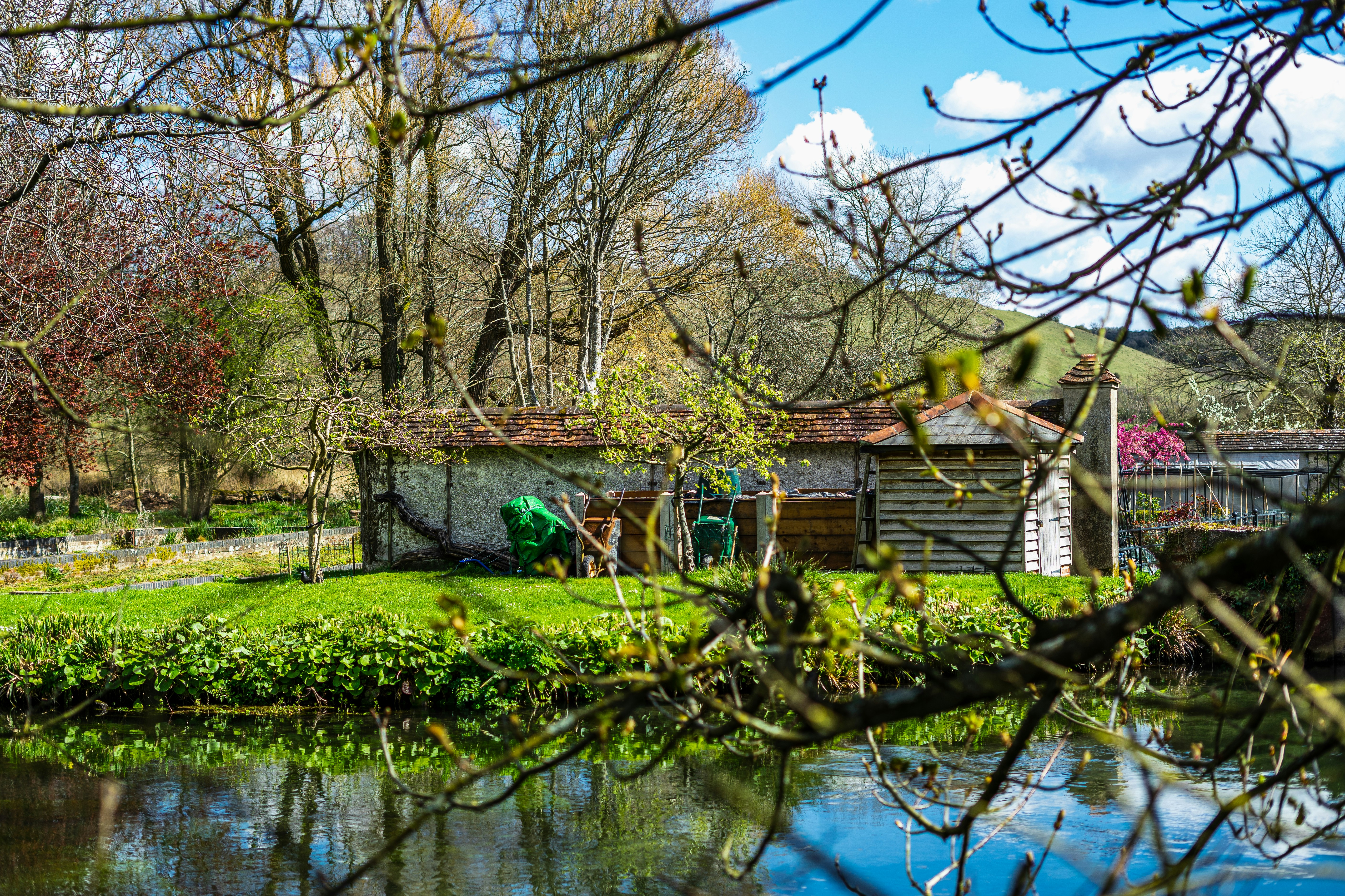 a small house sitting next to a river