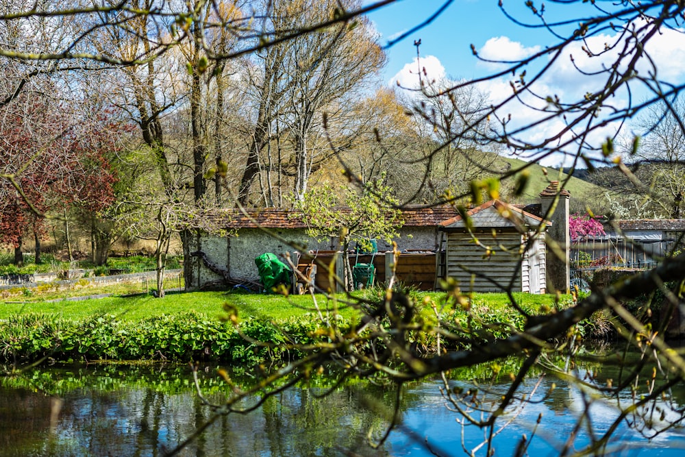 a small house sitting next to a river