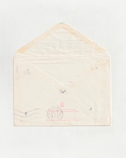 a white envelope with a red stamp on it