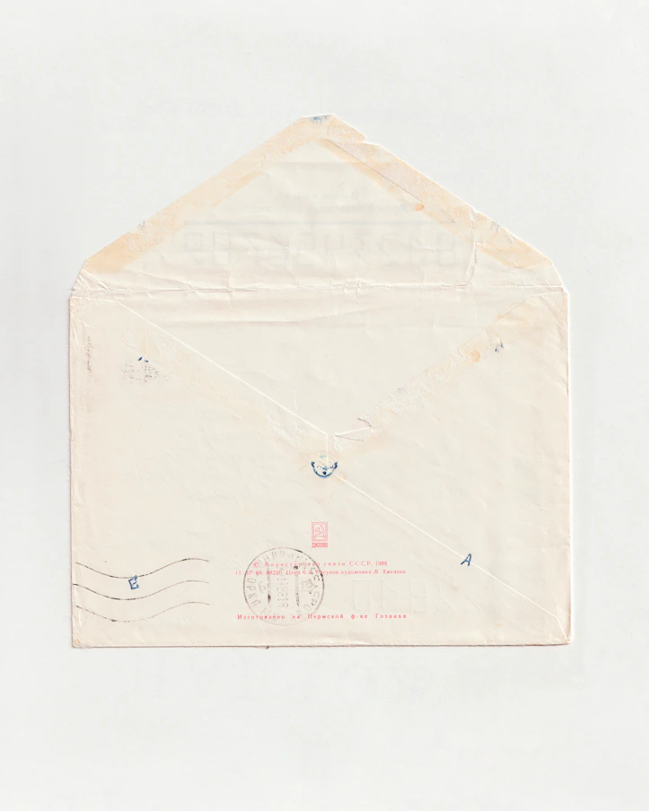 a white envelope with a red stamp on it