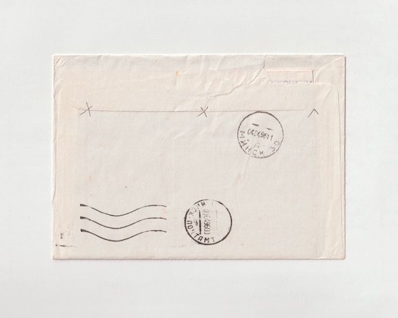 An old envelope with rare postmarks from around the world displayed on a dark background.