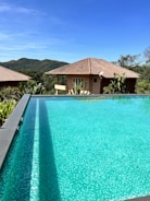 a large swimming pool in front of a house