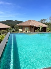 a large swimming pool in front of a house