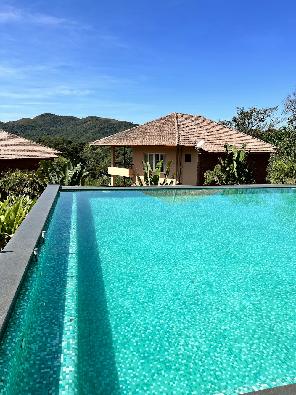 a large swimming pool in front of a house