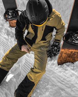 Close-up of a snowboarder adjusting a high-tech helmet equipped with sensors before hitting the slopes.