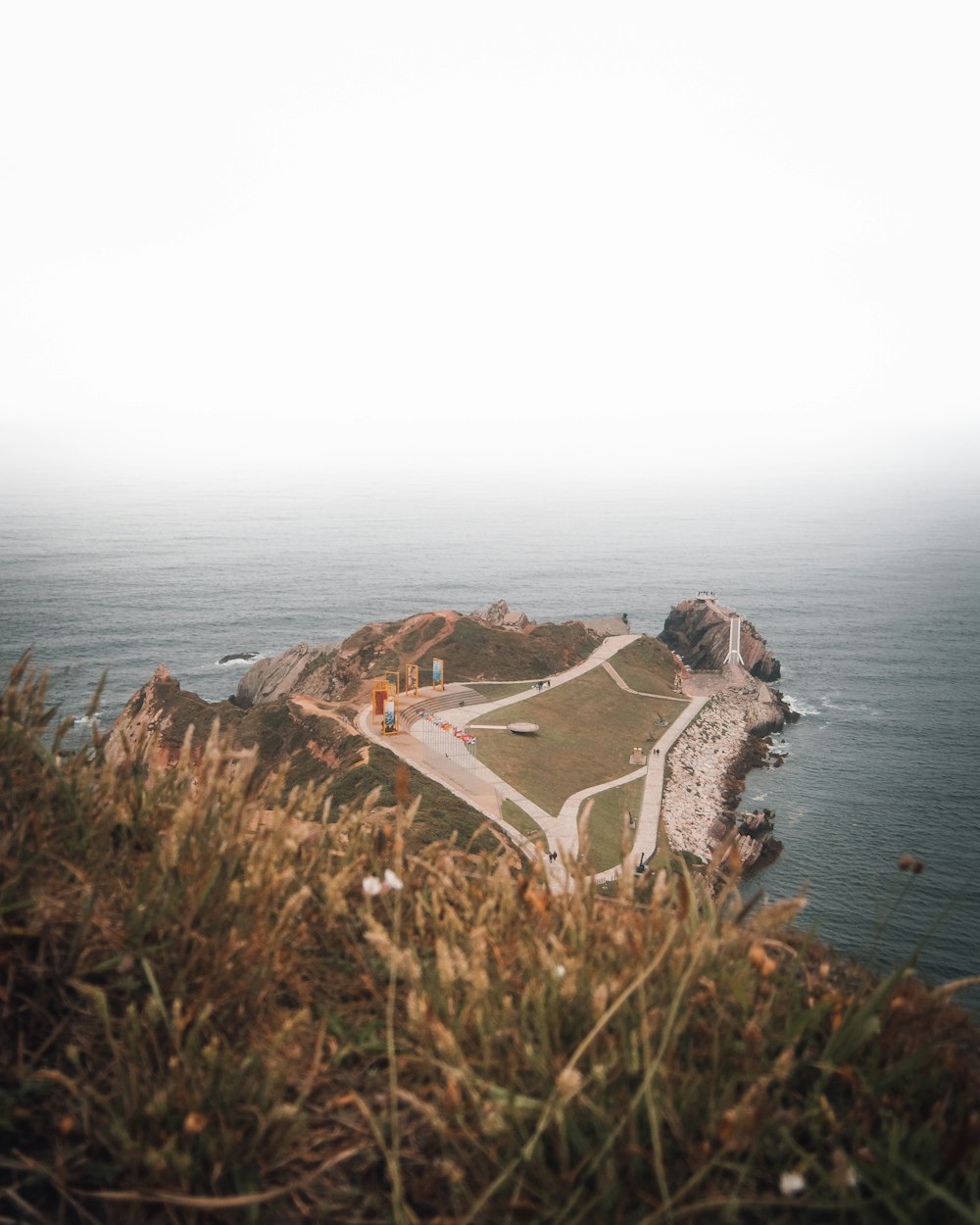 a view of a small island in the middle of the ocean