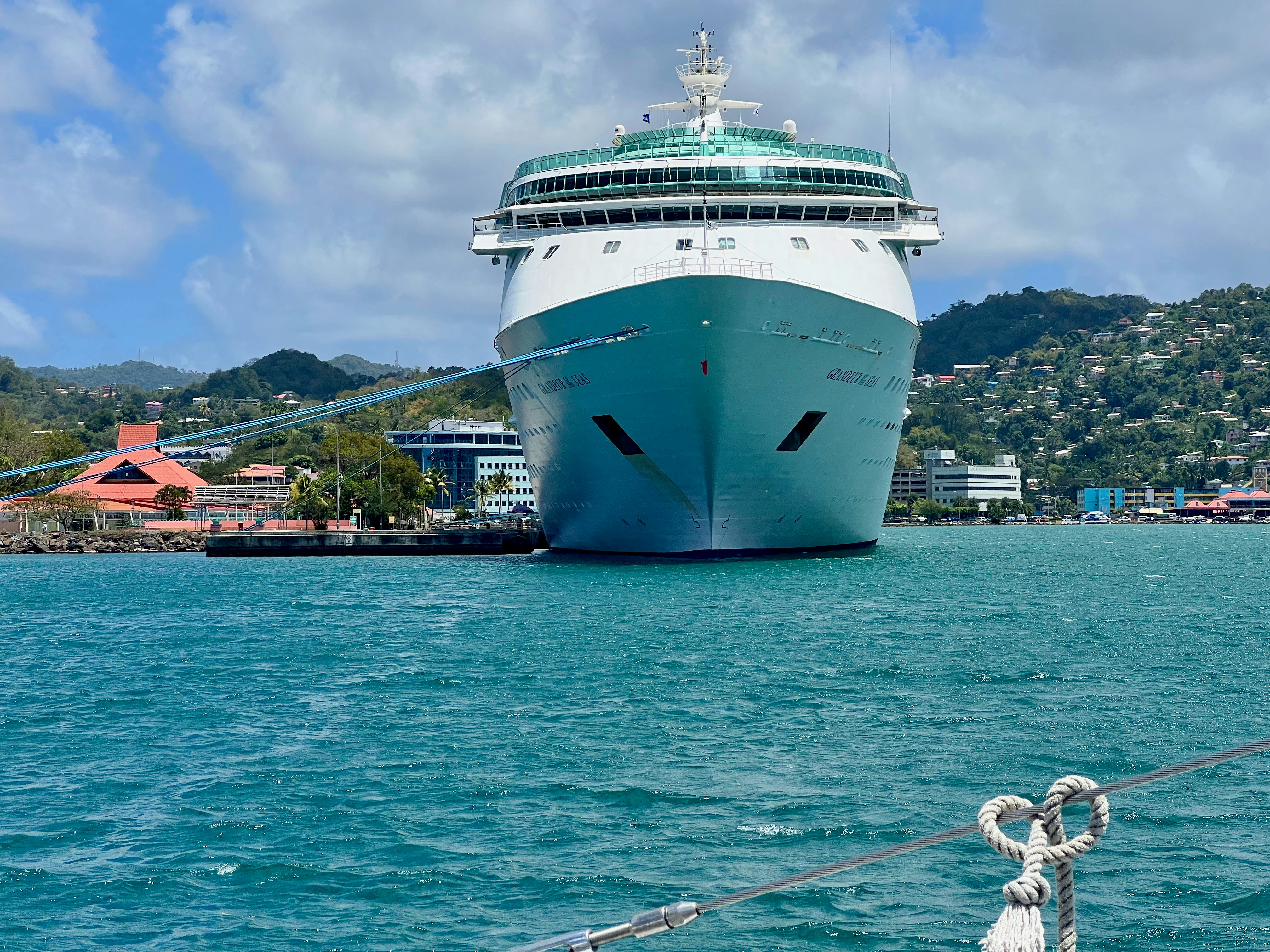 a large cruise ship docked in a harbor, 