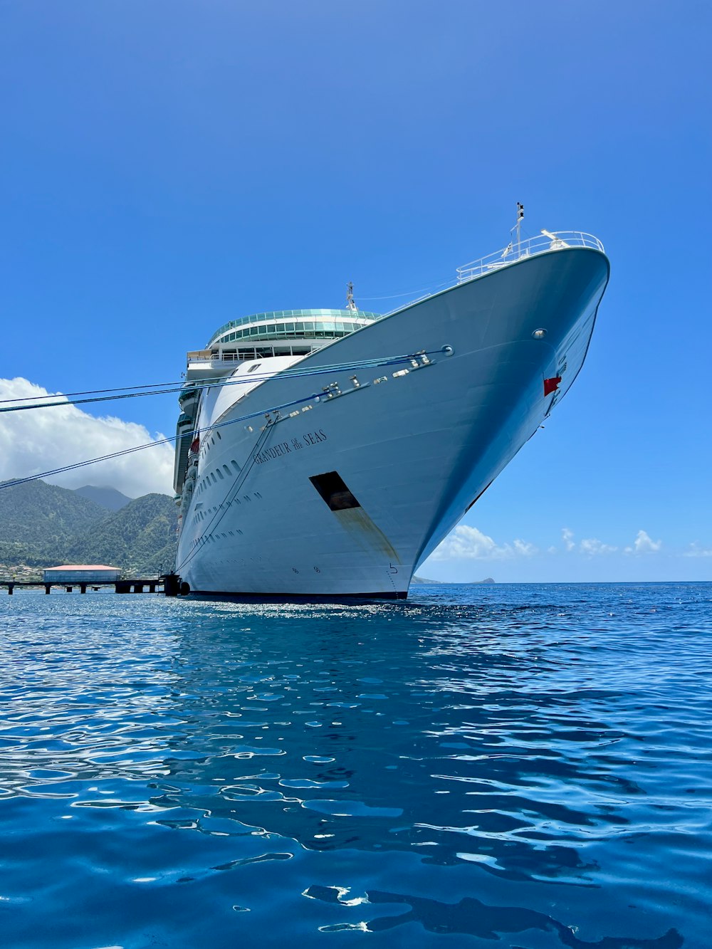 a large cruise ship in the water near a dock