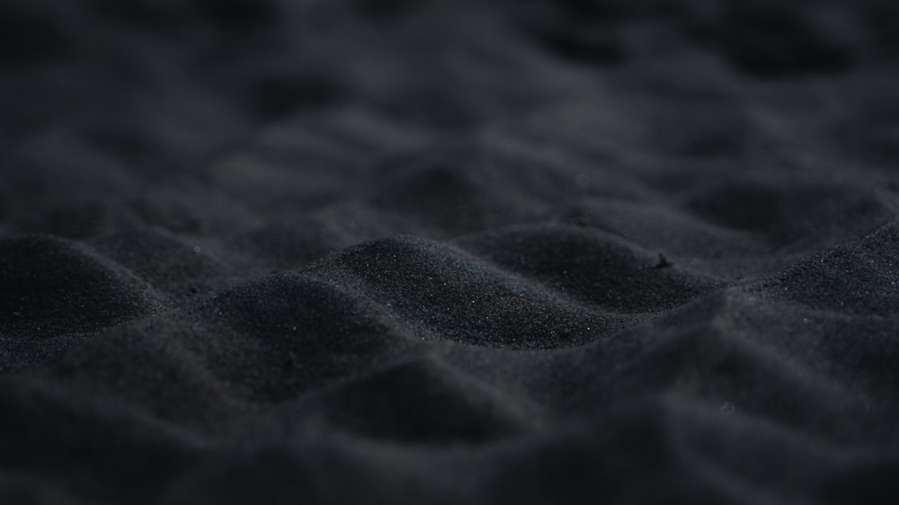 a close up of a black sand surface