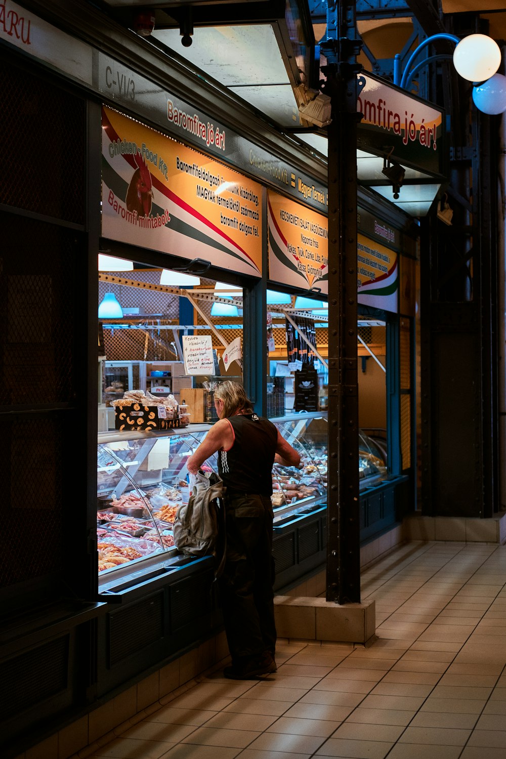 a woman standing in front of a store window