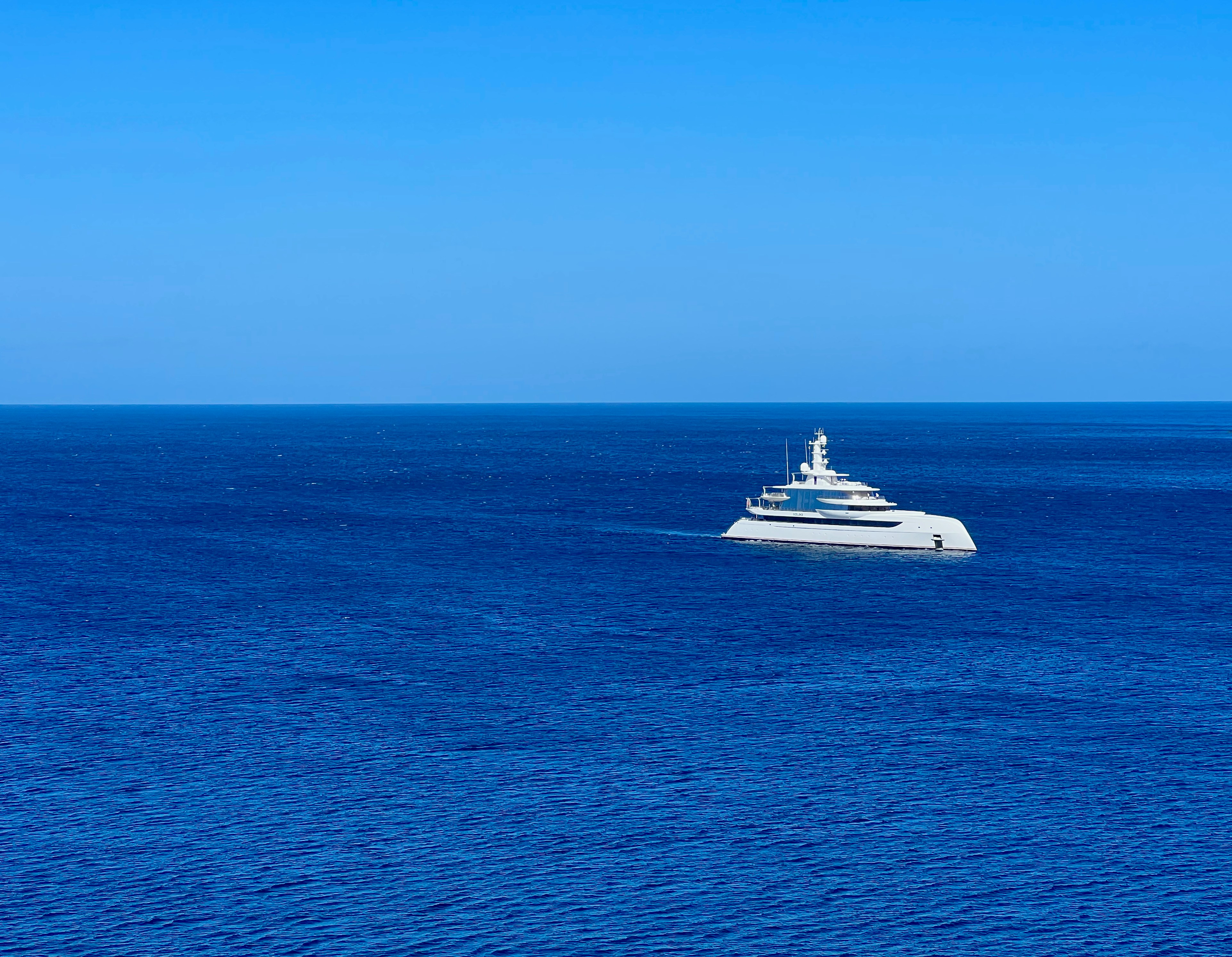 a large white boat in the middle of the ocean, 