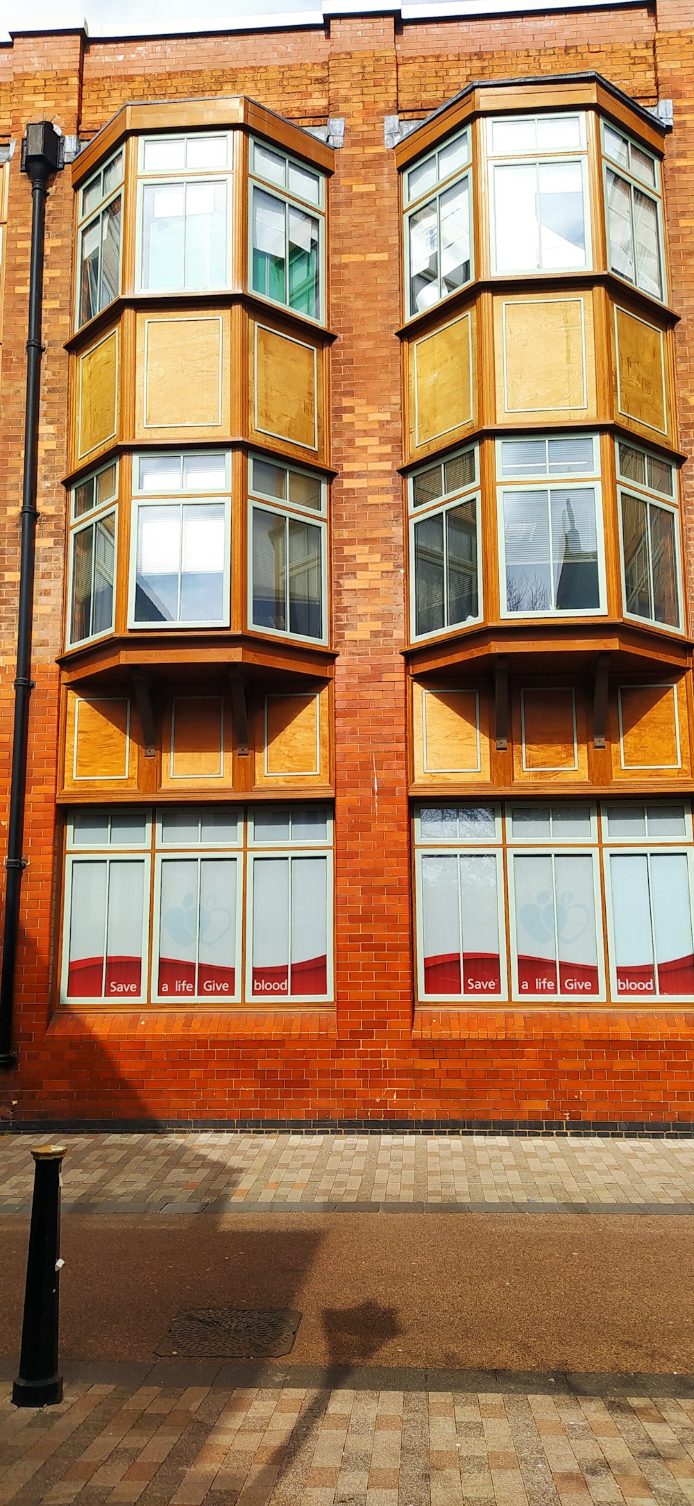 a red brick building with windows and a street light