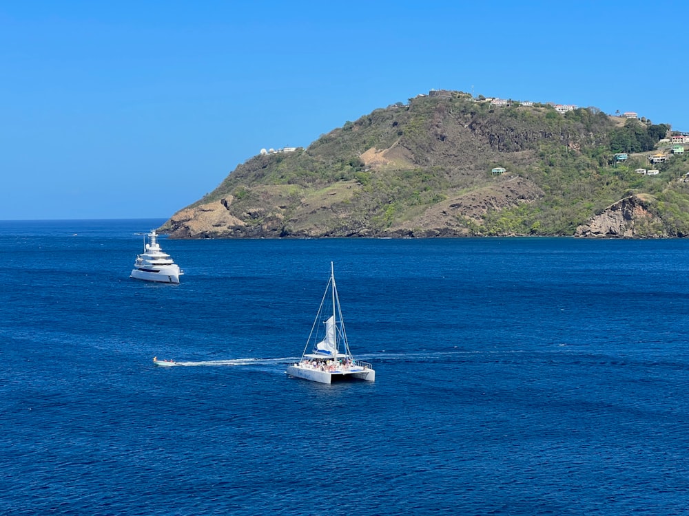 a couple of boats floating on top of a large body of water