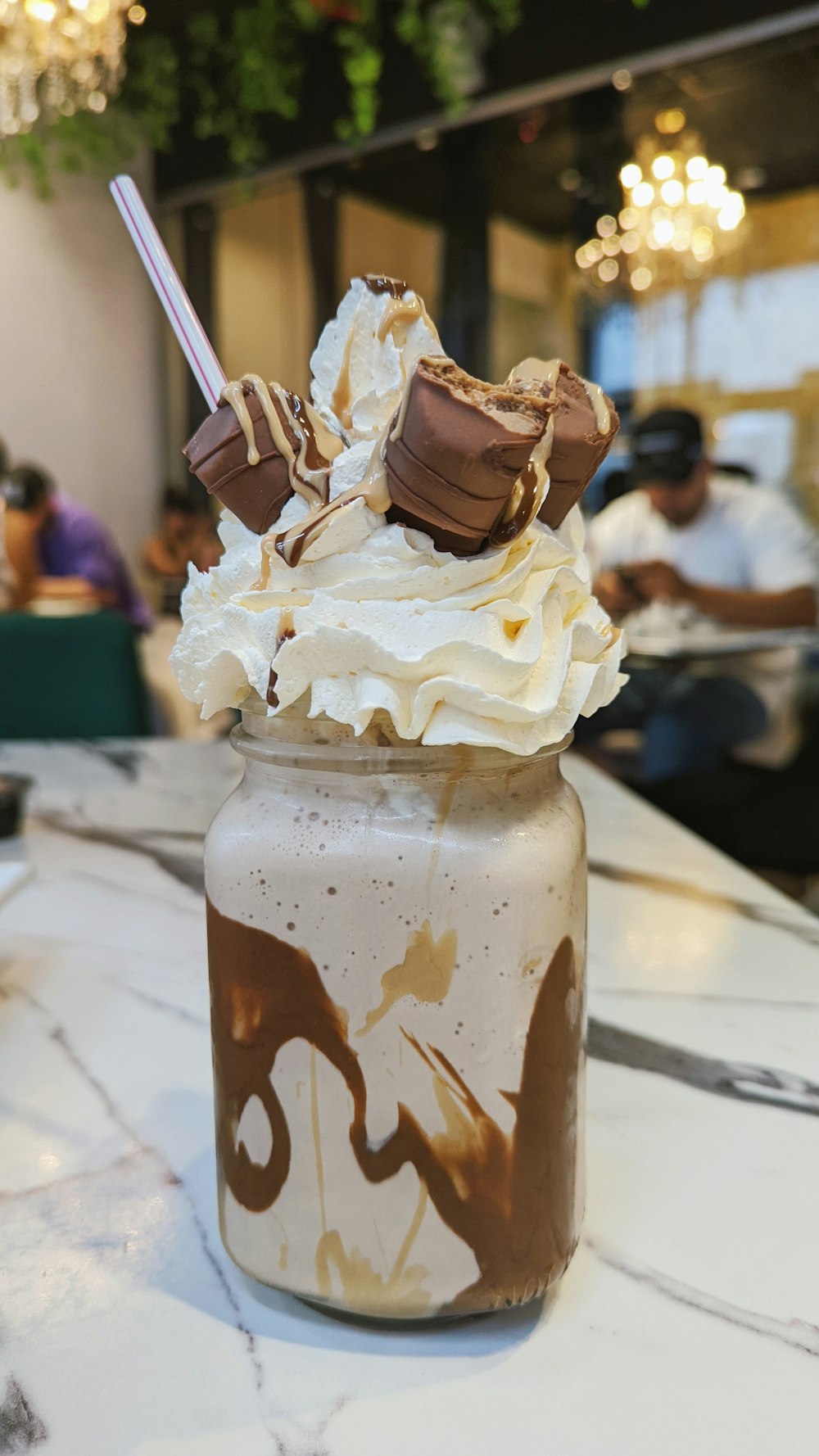 a glass jar filled with whipped cream and chocolate