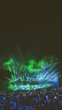 Wide shot of an outdoor drone light show illuminating a large crowd.