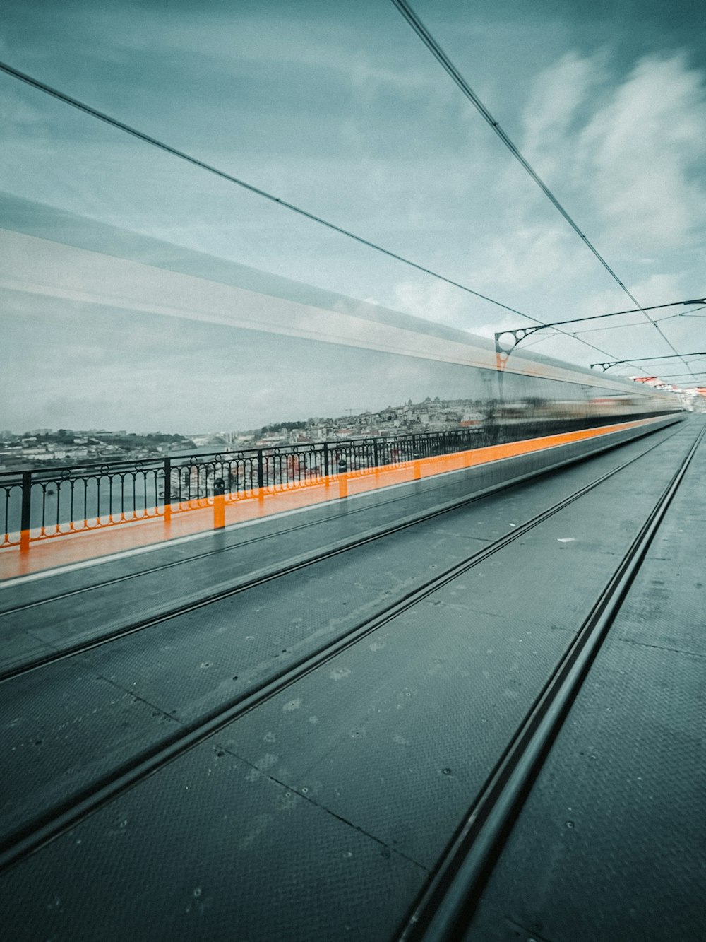 a train traveling down train tracks next to a bridge