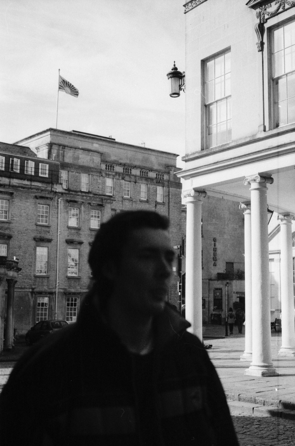 a man standing in front of a tall building